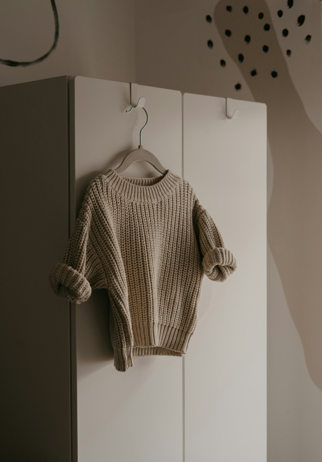 Chunky oatmeal knit sweater on a hanger
